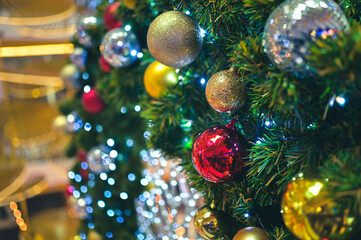 Obraz na płótnie Canvas Decorated Christmas tree and New Year holidays sparking, glowing. Happy New Year theme Blurred bokeh background