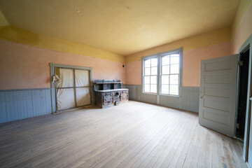 Empty, abandoned large room, with an old fashioned antique stove, in the Bannack ghost town