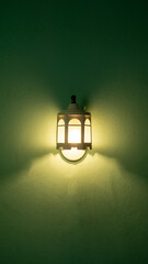 a White lamp hanging on the green wall