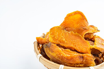 Dried sweet potatoes in a pot on white background
