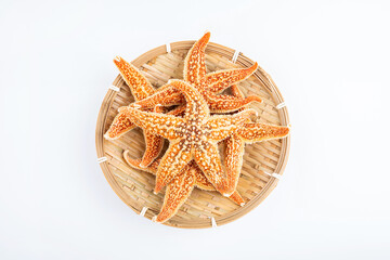 Fototapeta na wymiar Dried starfish with soup ingredients in a pot on white background
