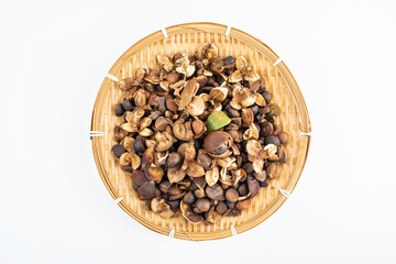 Camellia seeds in a pot on white background