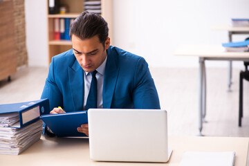 Young businessman employee taking notes in the office