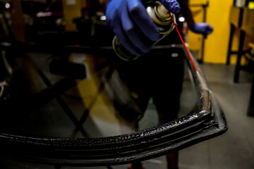 Person repairing a windshield
