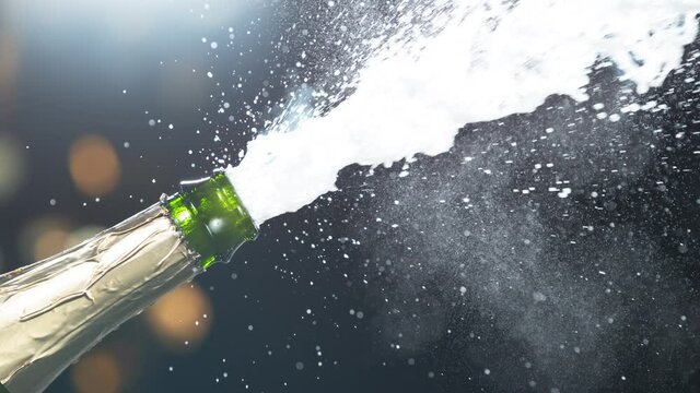 Super slow motion of Champagne explosion, opening champagne bottle closeup. Filmed on high speed cinema camera, 1000fps