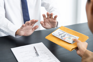 Businessman partner hand gesture rejecting refusing money, anticorruption concept.