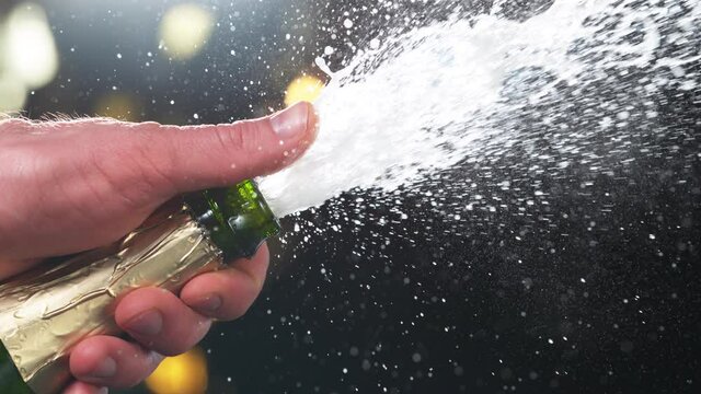 Super slow motion of Champagne explosion, opening champagne bottle closeup. Filmed on high speed cinema camera, 1000fps