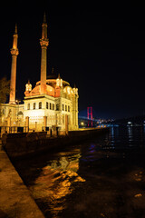 Ortaköy Mosque at night with Bosporus bridge background 