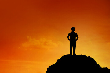 Silhouette of Businessman stand on the top of moutain , achievement , success and leadership concept.