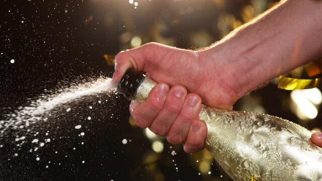 Super slow motion of Champagne explosion, opening champagne bottle closeup. Filmed on high speed cinema camera, 1000fps
