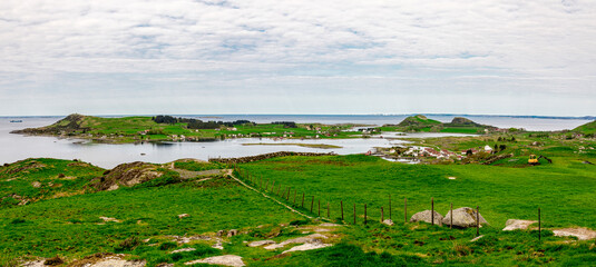 Green landscape of three islands in Rennesoy commune: Fjoloy, Klosteroy and Mosteroy from a track...
