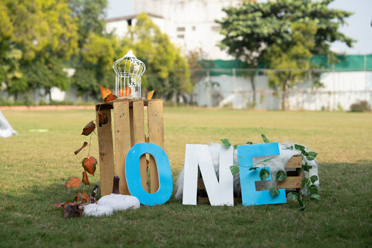 one letter with boxes and garden in background for photography