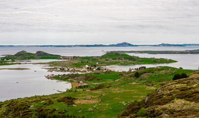 A view to a small village on Klosteroy island from top of Mastravarden hill on Mosteroy, Rennesoy kommune, Norway, May 2018