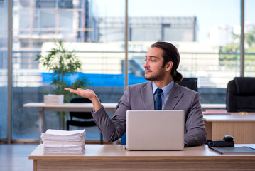 Young male employee working in the office