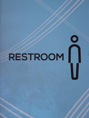 Male restroom sign on light blue background.
