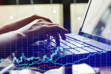 Financial chart hologram, graph on office laptop top view. Concept for analytics, business, banking and accounting, investment. Mixed media.