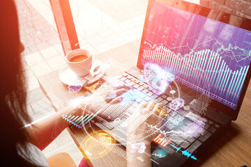Financial chart hologram, graph on office laptop top view. Concept for analytics, business, banking and accounting, investment. Mixed media.