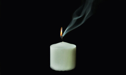 burning candle on black background
