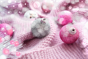 Obraz na płótnie Canvas Closeup of Festively Decorated christmas shiny balls on knitted fluffy blanket, bokeh effect, winter mood