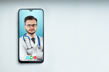 Portrait of a man, a doctor on a smartphone screen, a video conference, an appointment with a doctor online. Medical technology concept, the future of medicine. Mixed media.