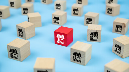 Close-up cube wooden toy blocks with franchise business store icon. For business is growth and...