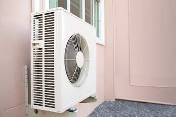 External split wall air conditioner compressor unit  installed on the outside of the building.