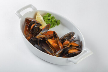 Blue mussels in tomatoes, white background