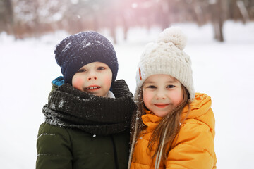 Happy family playing and laughing in winter outdoors in the snow. City park winter day.