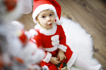 Merry bright christmas. Lovely baby enjoy christmas. Childhood memories. Santa girl little child celebrate christmas at home. Family holiday. Girl cute child cheerful mood play near christmas tree.
