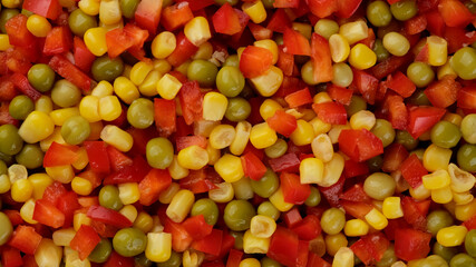 mixed vegetables chopped paprika pepper, canned green pea and corn. frozen vegetables top view