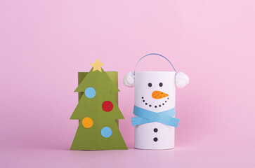 children's Christmas toys made of paper on a pink background