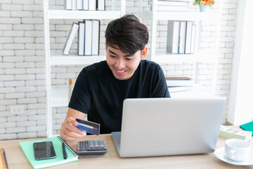 A man paying for online shopping using laptop and credit card. This image is illustrated the online...