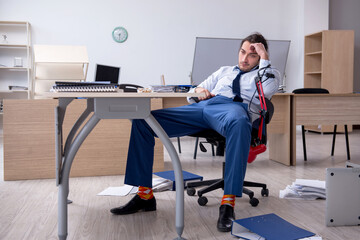 Young male employee unhappy with excessive work