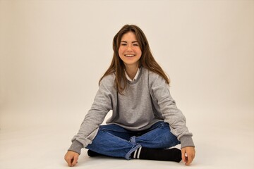 Beautiful blower sits on the floor of a student white background the joy of meditation calm happiness smile