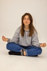Fototapeta premium Beautiful blower sits on the floor of a student white background the joy of meditation calm happiness smile