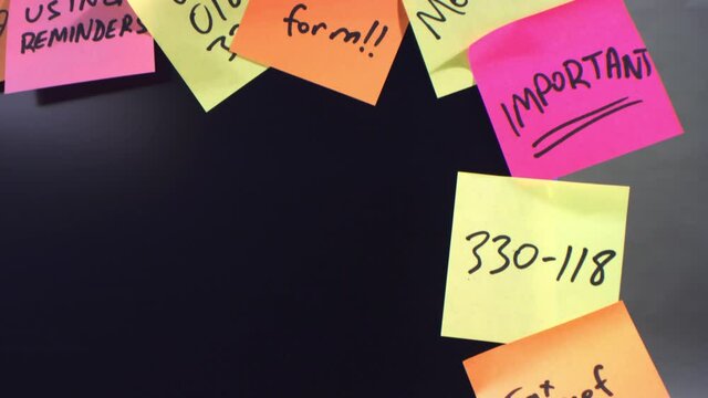 Seamless looping close-up dolly shot, color reminder sticky notes attached to the office monitor. Multitask stress concept