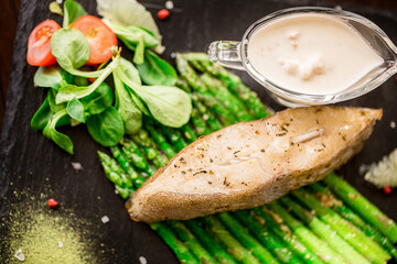 fish steak, asparagus, vegetables and spices.