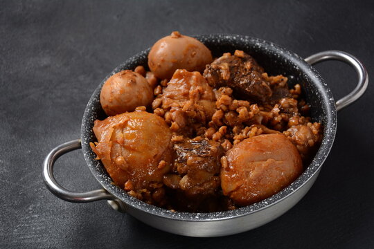 Jewish cuisine - Cholent (Hamin).Traditional main dish for Jewish Shabbat lunch, slow cooked beef Stew with potato, beans, barleys, wheat and brown eggs in a metal casserole