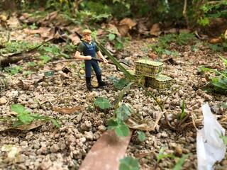 Naklejka premium miniature man cleaning wheat