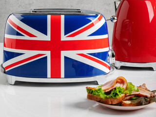 Stylish toster for bread. Toaster with a British flag. Stylish Breakfast. Modern appliances. Toast with bacon and salad. English breakfast. - obrazy, fototapety, plakaty