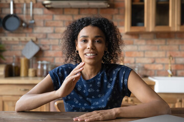 Web camera view focused young african american woman talking, involved in video call conversation....