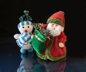 Grandparent Frost in caftan with bag toy on turn blue table