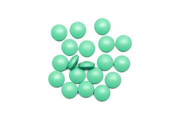 Green medicine pill isolated on the white background.