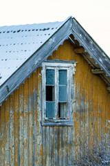 farmhouse window of yellow house