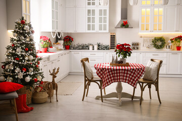 Beautiful kitchen interior with Christmas tree and festive decor