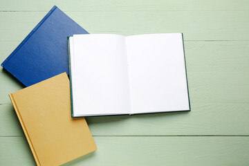 Blank books on color wooden background