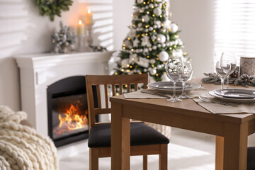 Festive table setting and beautiful Christmas decor in living room. Interior design