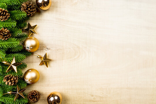 Christmas ball and pine tree with xmas decoration on wooden background
