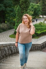 Beautiful woman on a walk in the city. Autumn- Winter time. A nice middle aged plus size woman at the street. Citizen lifestyle