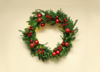 Fototapeta na wymiar Beautiful Christmas wreath with festive decor on beige background, top view